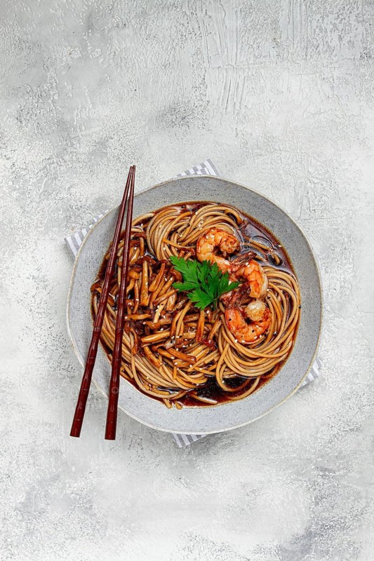 Soba, buckwheat noodles, with shimeji mushrooms and tiger shrimps, sesame, lime, parsley, homemade, no people