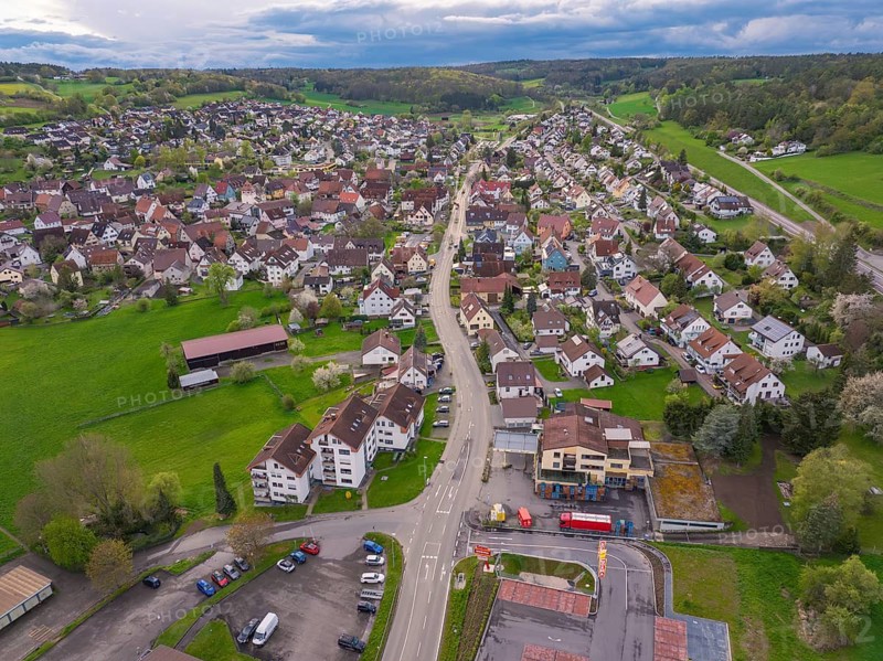 Village view with a central street surrounded by houses and green land, Ostelsheim, district of Calw, Germany