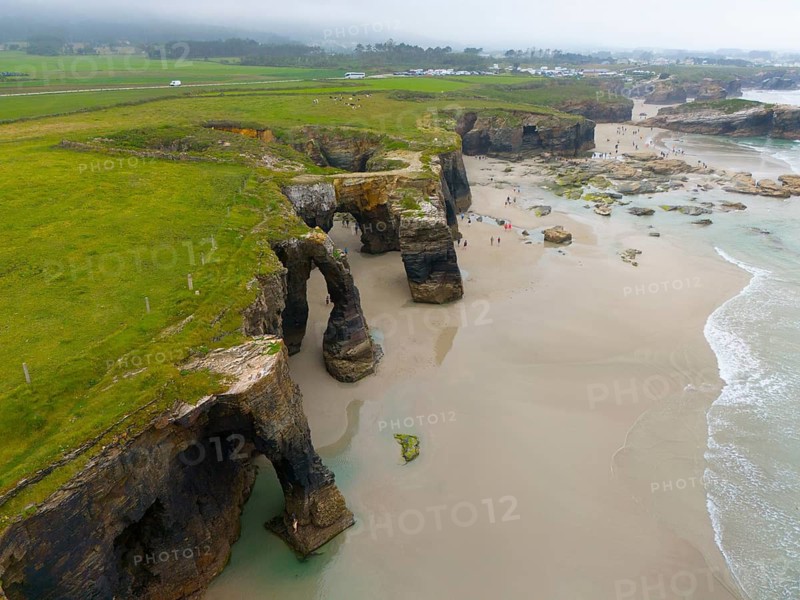 Aerial view of rocky cliffs and arches on a subtropical coast with green vegetation and sandy beaches, Aerial view, Praia das Catedrais, Playa de las Catedrales, Cathedral beach, As Catedrais beach, Cantabrian Sea, Ribadeo, Galicia, Galicia, Spain