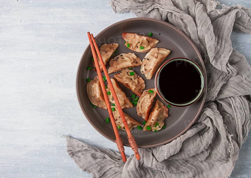 Japanese Gyoza dumplings, fried, with sauce, top view, without people, tinted, selective focus