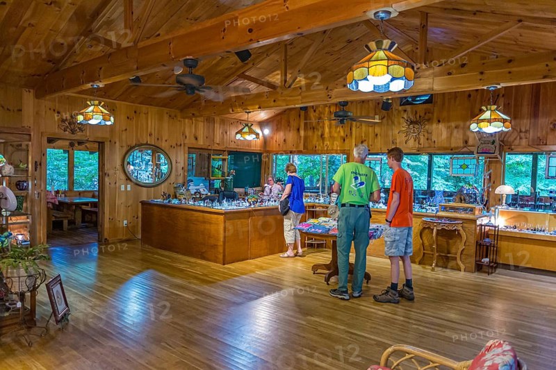 Customers shop and observe a glass blowing demonstration at Butts On The Creek restaurant and gift shop in Maggie Valley, NC