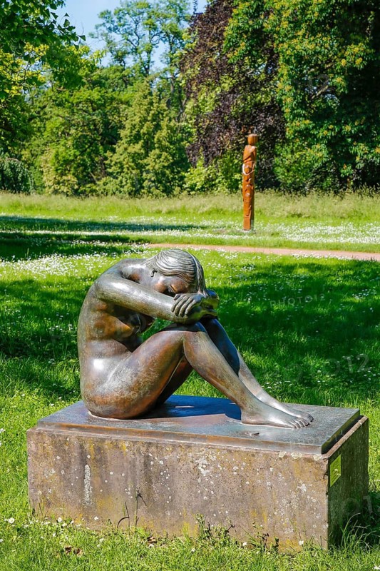 Public art, sculpture by Hermann-Christian Zimmerle sculptor, nude Eva, female figure, bronze sculpture, castle garden, castle park, Varbüler castle, Hemmingen castle, Hemmingen, Ludwigsburg district, Baden-Württemberg, Germany