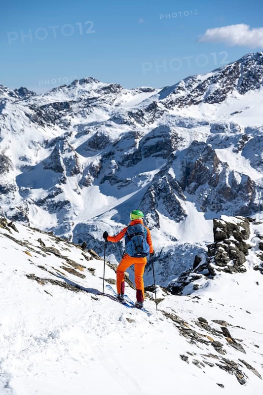 Ski tourer in front of a mountain panorama with snow-covered mountain landscape in winter, Ortler Alps, Vinschgau Valley, Italy