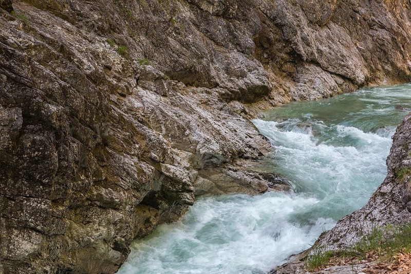 The Lammer creek is flowing fast through the Lammerklamm on a sunny hiking day