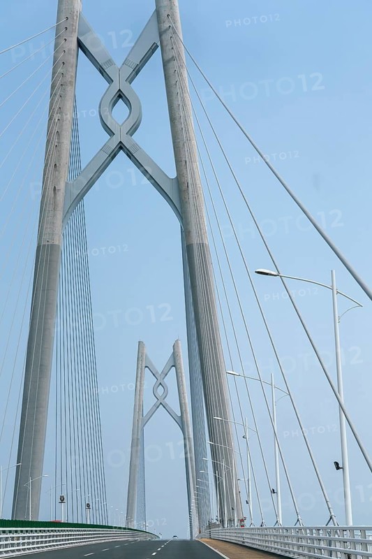 Image showcasing the impressive architecture of the Hong Kong-Zhuhai-Macau Bridge, the longest sea-crossing bridge, featuring its unique cable-stayed towers and expansive deck in daylight