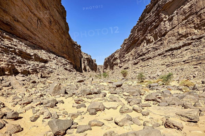 Open rocky canyon landscape with clear blue sky, rocky canyon in the desert landscape of the Sahara in Algeria
