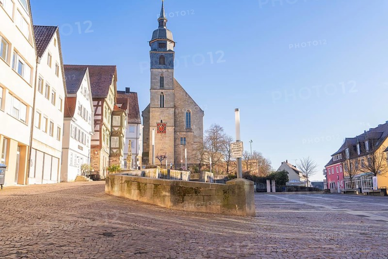 Old town scene with cobblestones and a church, illuminated by the sun, Böblingen, Germany