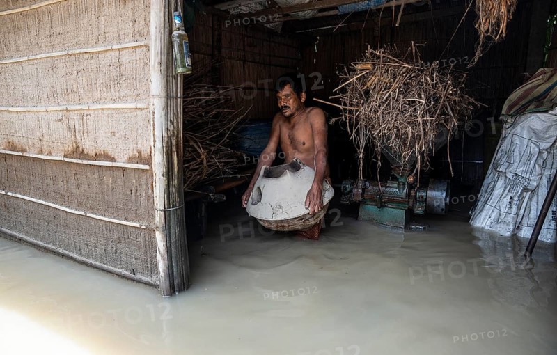 Morigaon, India. 4 July 2024. A person try to save his belongings in his flooded house, in a flood affected village in Morigaon district in India's northeastern state of Assam on July 4, 2024. Torrential rains and surging rivers across northeast India have killed at least nine people, with more than 1.5 million people affected
