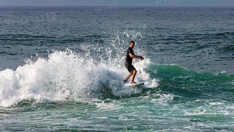 Surfer shows off his skills on impressive waves, surfers in the Indian Ocean at Galle in Sri Lanka