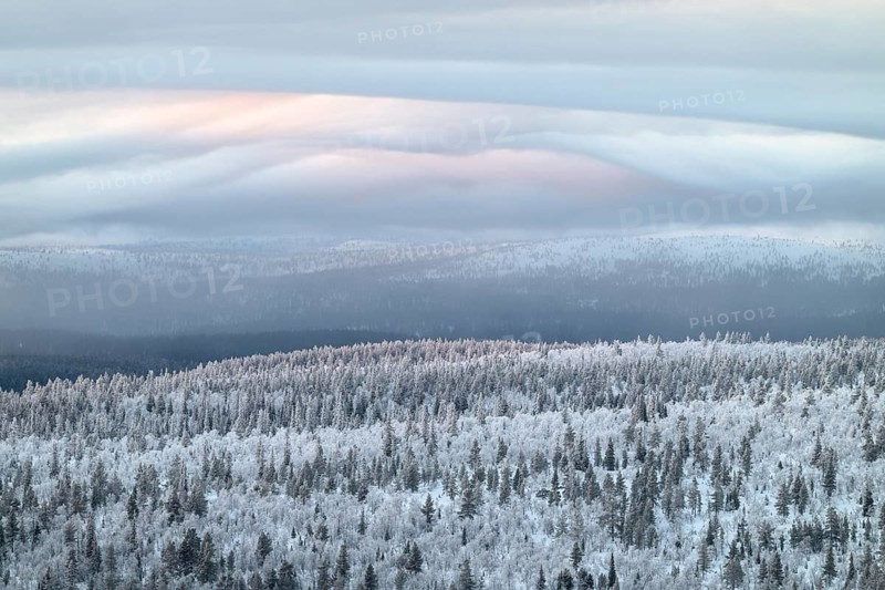 Clouds over forested mountain ranges, Saariselkä, Lapland, Finland, January 2025