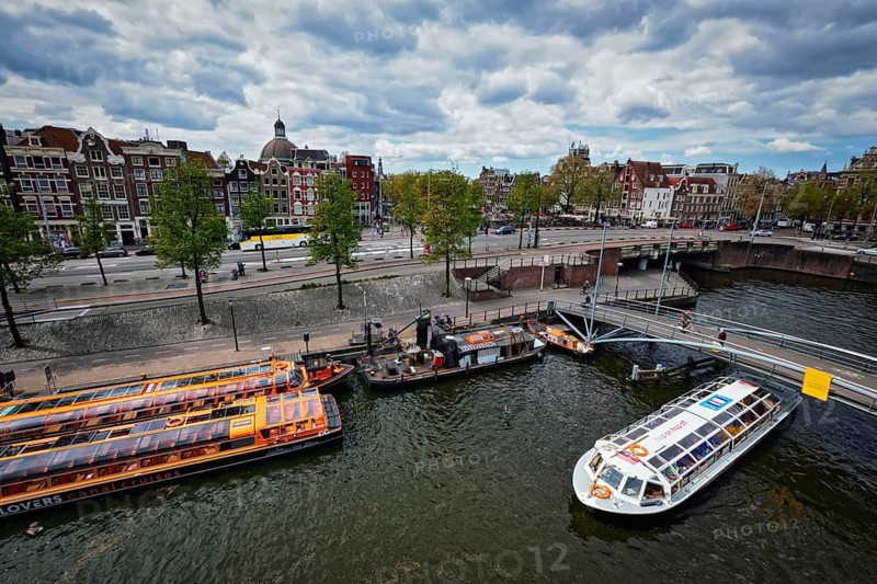 AMSTERDAM, NETHERLANDS, MAY 9, 2017: Aerial view of Amsterdam canal with tourist boats near Amsterdam Centraal
