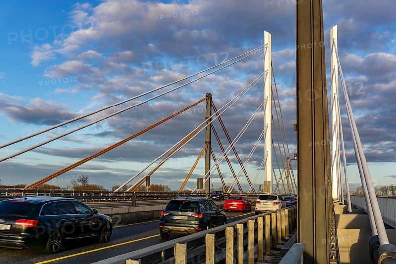 Traffic on the A40 Neuenkamp bridge, piers and stay cables of the new motorway bridge over the Rhine near Duisburg, the old bridge in the background is currently being dismantled, then the second part of the Neuenkamp bridge will be built, North Rhine-Westphalia, Germany