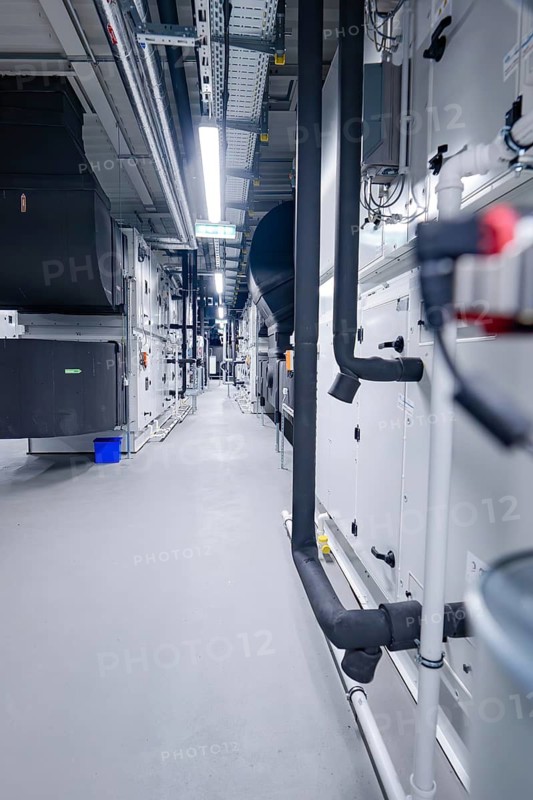 Aisle of an industrial ventilation system with visible pipes and machines in neutral colors, ventilation system, technical room, Calw, Germany