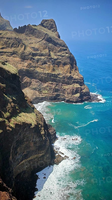 High cliffs with lush vegetation above the turquoise sea under clear skies, hiking, Santo Antao, Cabo Verde, Cape Verde, Cape Verde