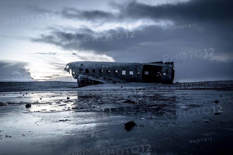 Plane wreck, crahsed plane on frozen Solheimasandur beach in winter with snow in Iceland