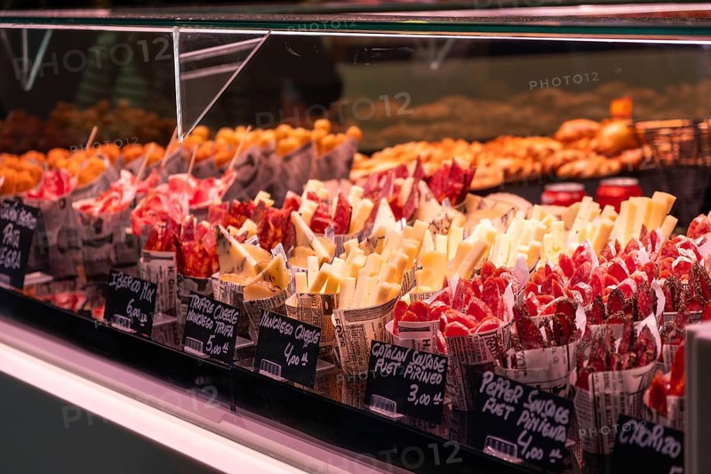 Market stall with sausage products at La Boqueria Market in Barcelona, Spain