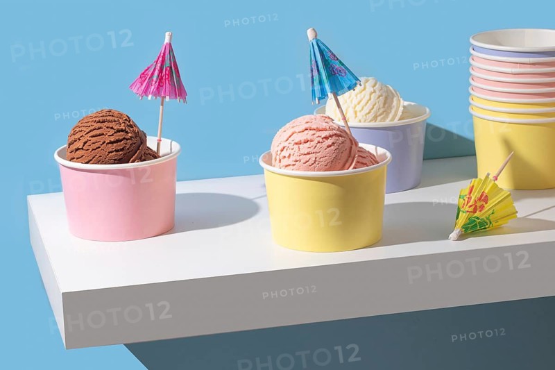 A minimalist presentation of chocolate, strawberry, and vanilla ice cream. The bright colors and clean background create a modern, eye catching image