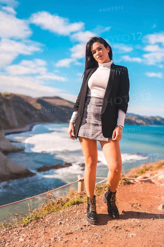 Lifestyle, a young brunette enjoying a summer afternoon on the coast of the basque country, zumaia. Gipuzkoa