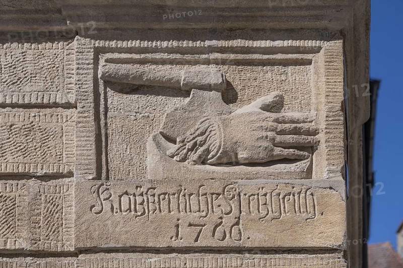 Relief of a chopped-off hand and an executioner's axe on the baroque Blue House, built around 1765, Rosenstraße 1 and 3, Weißenburg, Middle Franconia, Bavaria, Germany