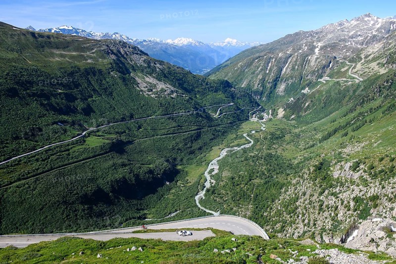 View from Furka road down the valley rhône to front bottom viewpoint on Rhone waterfall waterfall of Rhone left centre Furka road pass road to Furka pass centre river Rhone right back top steep mountain road to Grimsel pass, Alps, Canton Valais, Switzerland