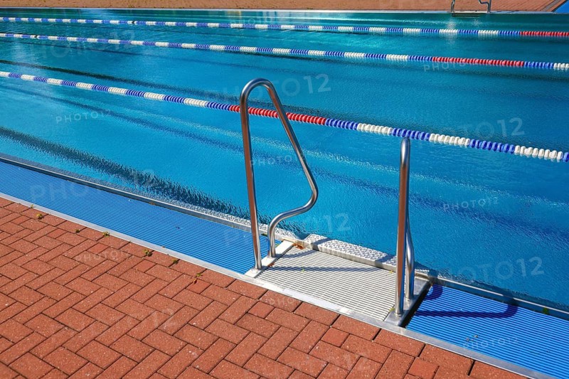 Hagen, North Rhine-Westphalia, Germany - Ladder at the edge of the swimming pool in the Hengstey outdoor pool