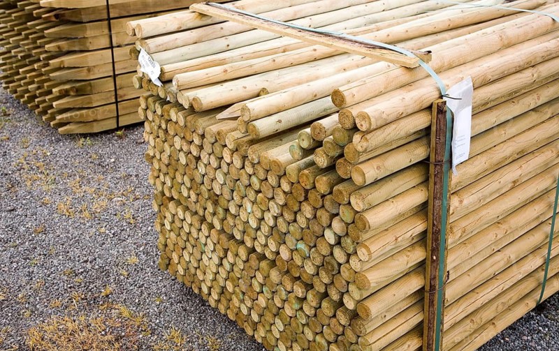 Wooden fence posts piled up in a builder's merchant yard, UK