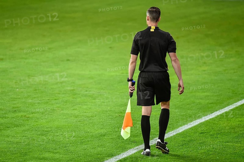 Assistant of football referee near the touchline.