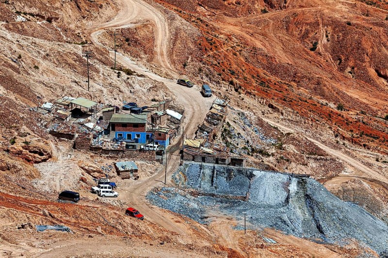 View of a small cluster of buildings and cars in a mining environment, The Potosi Silver Mines on Cerro Rico in Bolivia