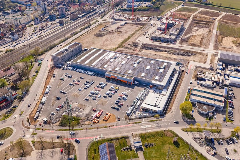 Extensive industrial area with retail, new buildings and solar cells taken from the air in an urban environment, PV plant at Obi Baumarkt, Mühlacker, Enzkreis, Germany