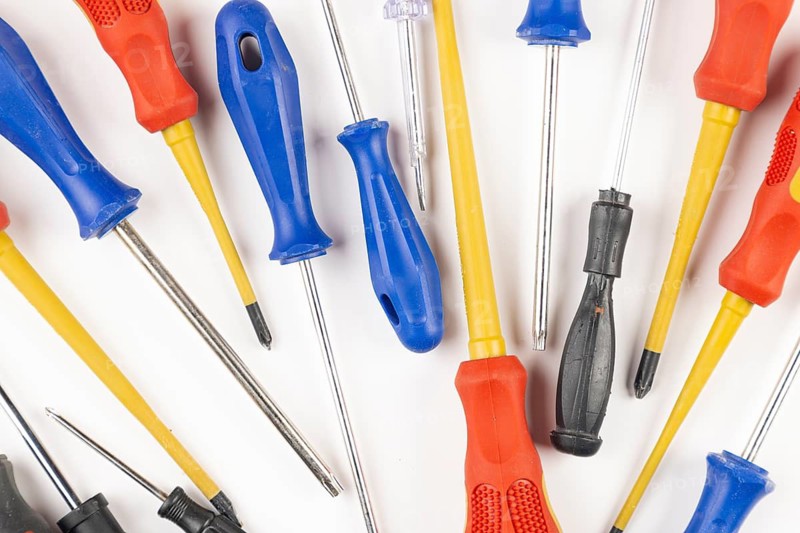 Different colorful screwdrivers on white background