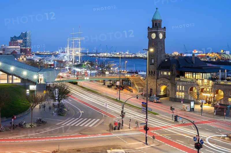 Piers with subway station and light strips of vehicles in the foreground with sailing ship Rickmers Rickmers and Elbe Philharmonic Hall zur Blaue Stunde, Jan Fedder Promenade, Hamburg, Germany