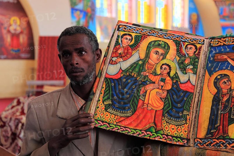 Tigray region, Axum, Aksum, St Mary's Cathedral, Maryam Tsion, inside, church servant shows old bible of the cathedral, Ethiopia