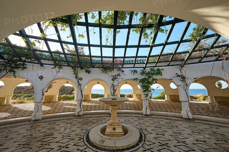 Bright courtyard with cobblestones and a central fountain, surrounded by white décor and sea views, thermal springs, thermal baths, thermal baths of Kallithea, Kallithea, Rhodes, Dodecanese, Greek Islands, Greece