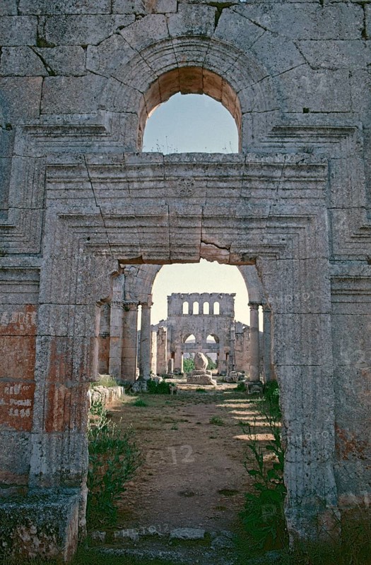 In front the north basilica, column, behind the south basilica with entrance, Monastery of St Simeon Stylites, Qal?at Sim?an, near Aleppo, Syria, May 1987, vintage, retro, old, historical