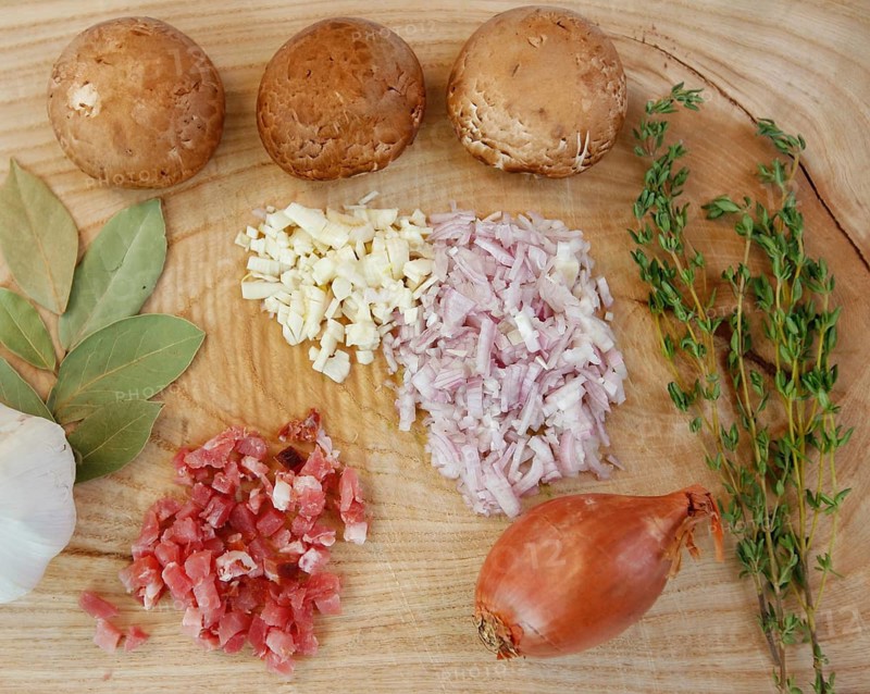 Ingredients on wooden board, preparation, mushrooms, dried bay leaves, onions, garlic cloves, minced, herbs, thyme, healthy cooking, smoked meat, smoked ham, food photography, studio, Germany
