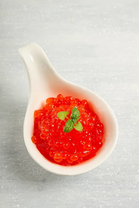 Red caviar, imitation, on a light background, close-up, no people