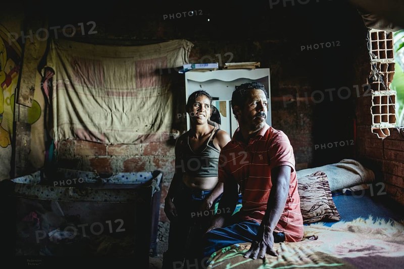 Maria and Nicomedes in their hut, Nicomedes has lost the sight in one eye due to an accident at work, he needs medication because his eye hurts and tears, Túrgua, Venezuela