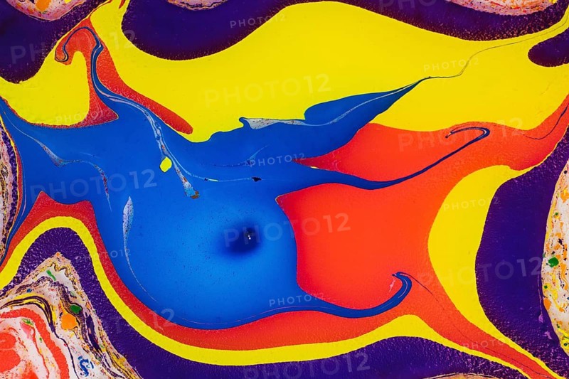 A vivid and colorful abstract composition featuring swirling patterns of blue, yellow, red, and orange paint, with accents of purple and white