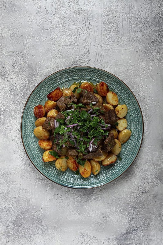 Kuyrdak, roast offal with potatoes and fresh herbs, homemade in Kazakh, no people