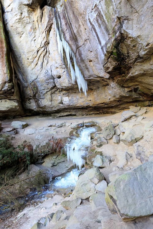 Frozen waterfall with icicles in the Gautschgrotte, Hohnstein, Saxony, Germany