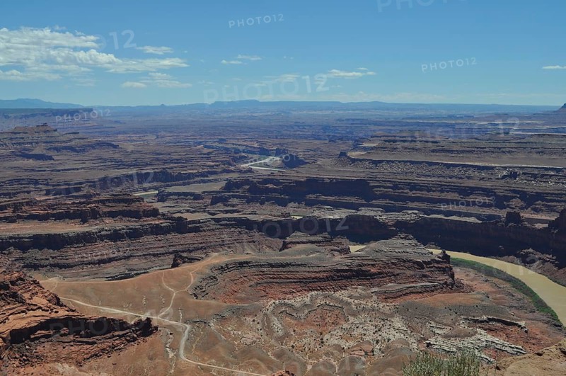 Wide view of deep canyons and layered rocks under clear skies, Dead Horse State Park, Moab, Utah, USA