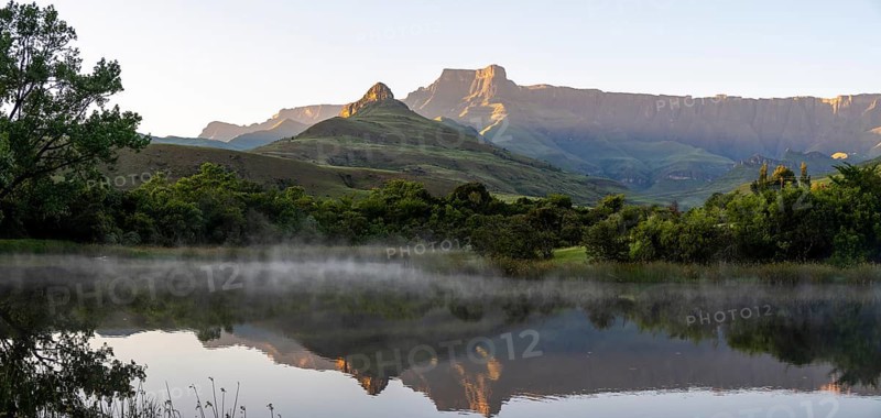 Sunrise, amphitheatre with reflection in the lake, Royal Natal National Park, Drakensberg Mountains south, Kwa Zulu Natal, South Africa