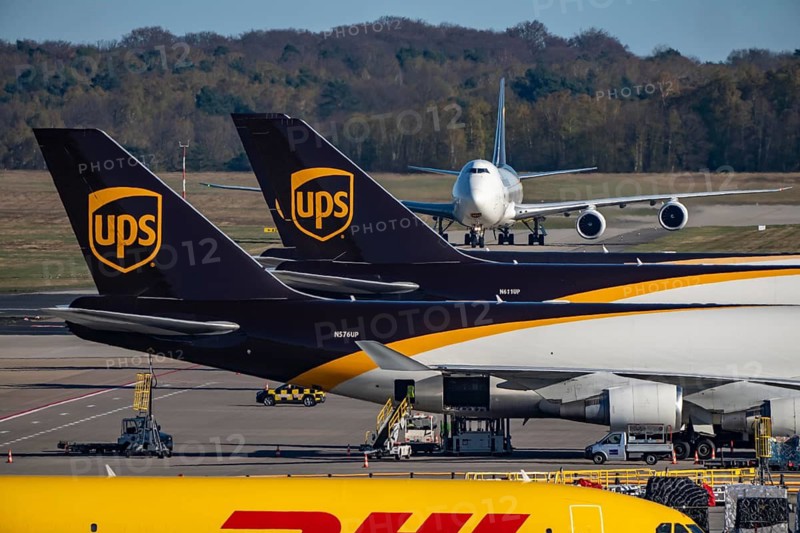 Cologne-Bonn Airport, CGN, UPS Boeing 747 freighter rolls after landing to the UPS Logisic Hub, cargo building, air freight center, and DHL cargo aircraft on the apron, at the logistics center