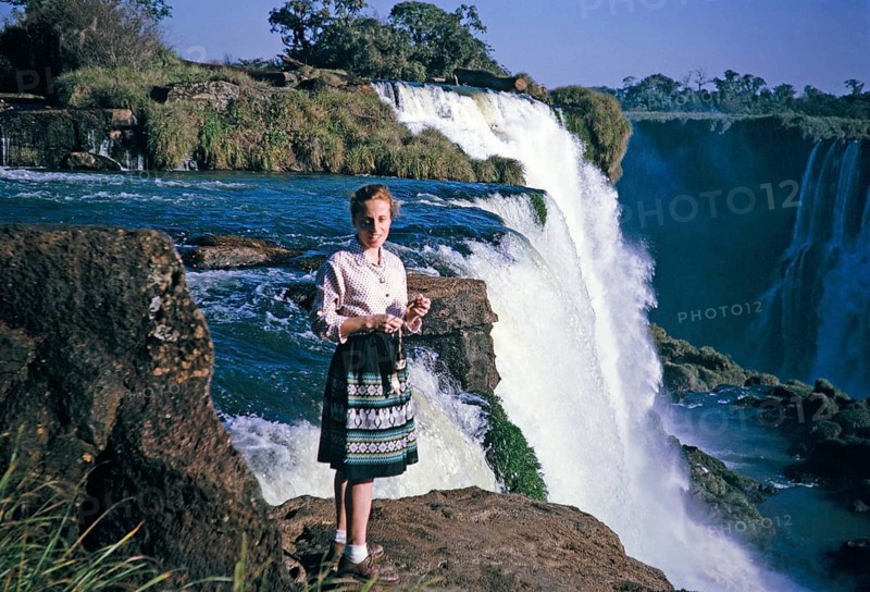 Iguazu Falls on the Iguazu River on the border between Brazil and Argentina, South America in 1962 Tourists standing
