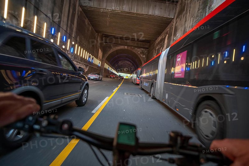 Cycling in the city, city centre road, no cycle path, tunnel, two-lane traffic in both directions, cyclists' perspective, Essen, North Rhine-Westphalia, Germany