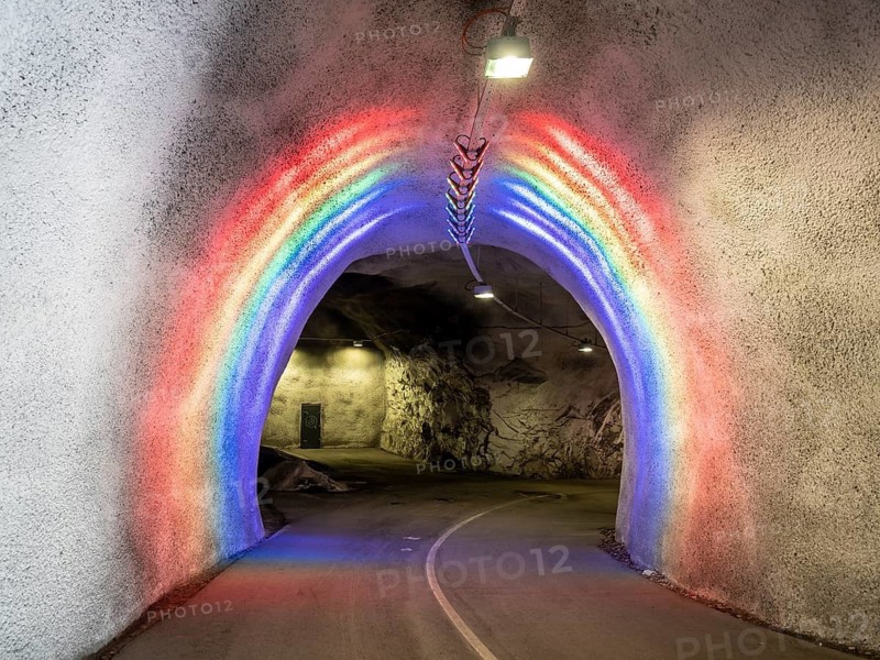 Colorful illuminated tunnel for bicycles and pedestrians leads up to Hardanger suspension bridge, Hardanger, Norway