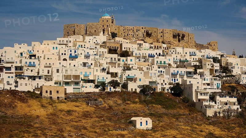 A historic fortress above a cluster of white houses and dry grass, Querini Castle, Chora, Astypalea, Dodecanese, Greek Islands, Greece