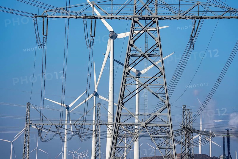 Wind farm at Eemshaven coal power plant, power lines, high-voltage pylon, substation, Eemshavencentrale, operated by RWE Generation, one of the 3 large power plants in the Eemshaven energy park, has an output of up to 1.6 GW, Groningen province, the Netherlands