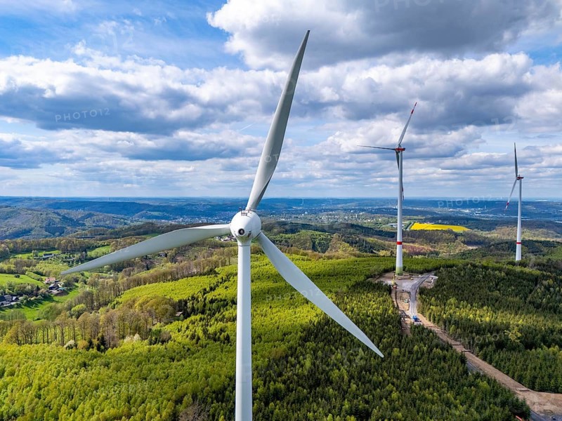 Erection of a wind turbine, wind energy plant, assembly of the ring generator, with a crawler lattice crane, wind farm near Hagen, North Rhine-Westphalia, Germany