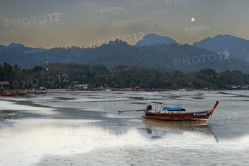 Before sunrise, longtail boats lie at low tide in the harbour at Sivalai Beach, Koh Mook Island, Satun Province, Southern Thailand, Thailand